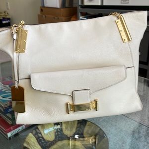 Lauren ivory leather shoulder bag featuring gold hardware. Good condition. Feet.
